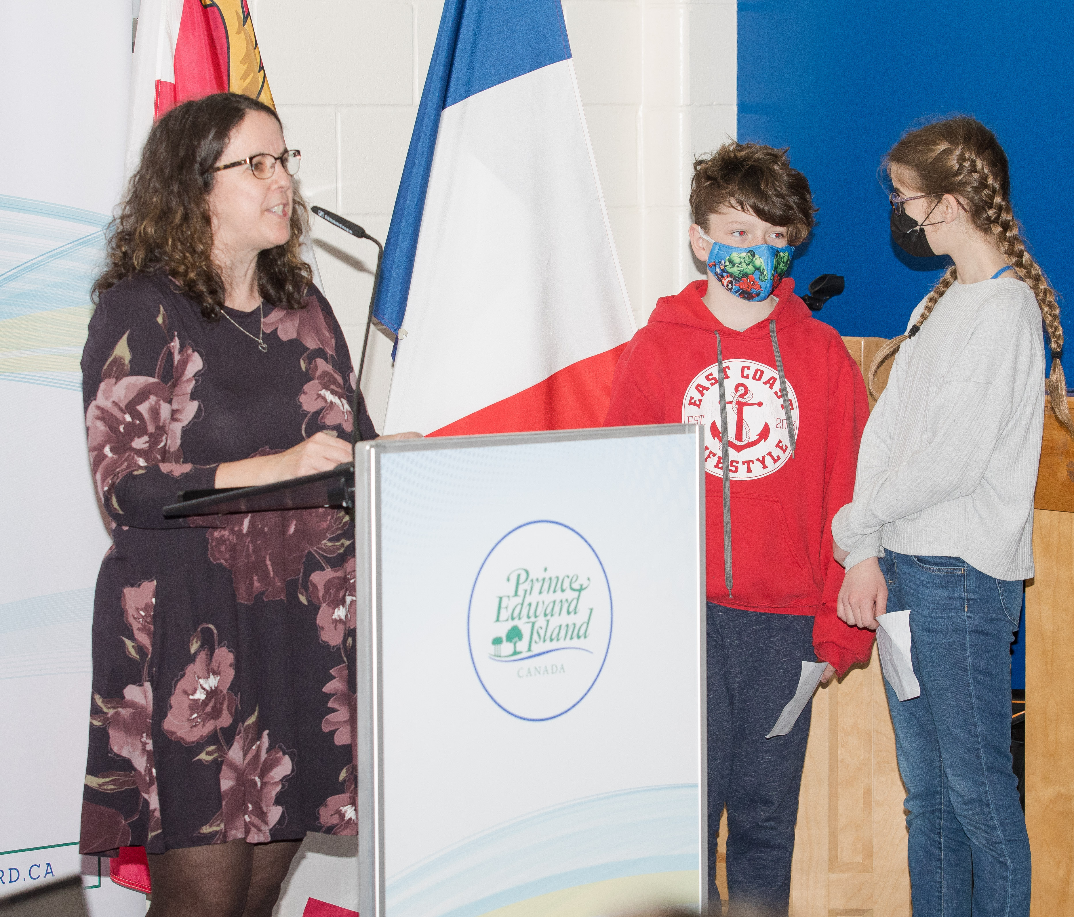 Paulette LeBlanc speaking at podium while students look on