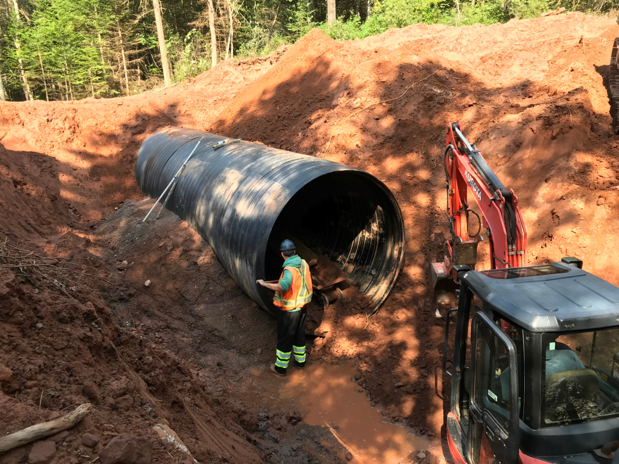 Crews work to install a culvert to aid in fish passage.
