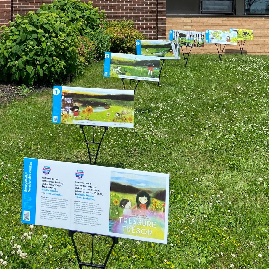 image of small colourful lawns signs in front of a school