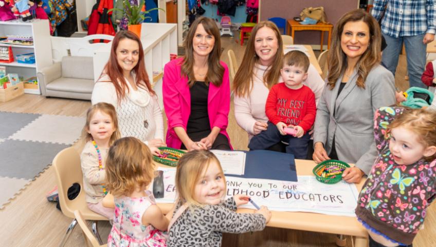 image of some adults and children with early years children in a classroom