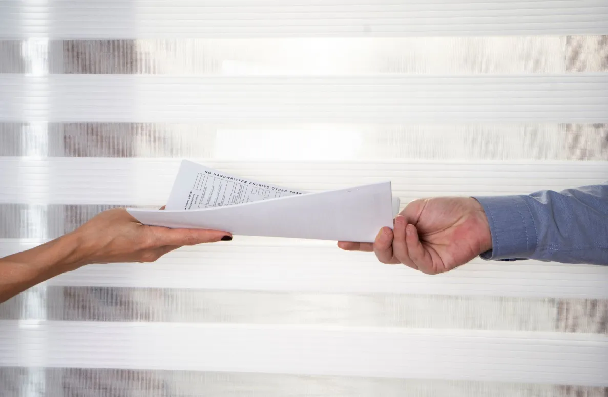 someone passing someone some papers