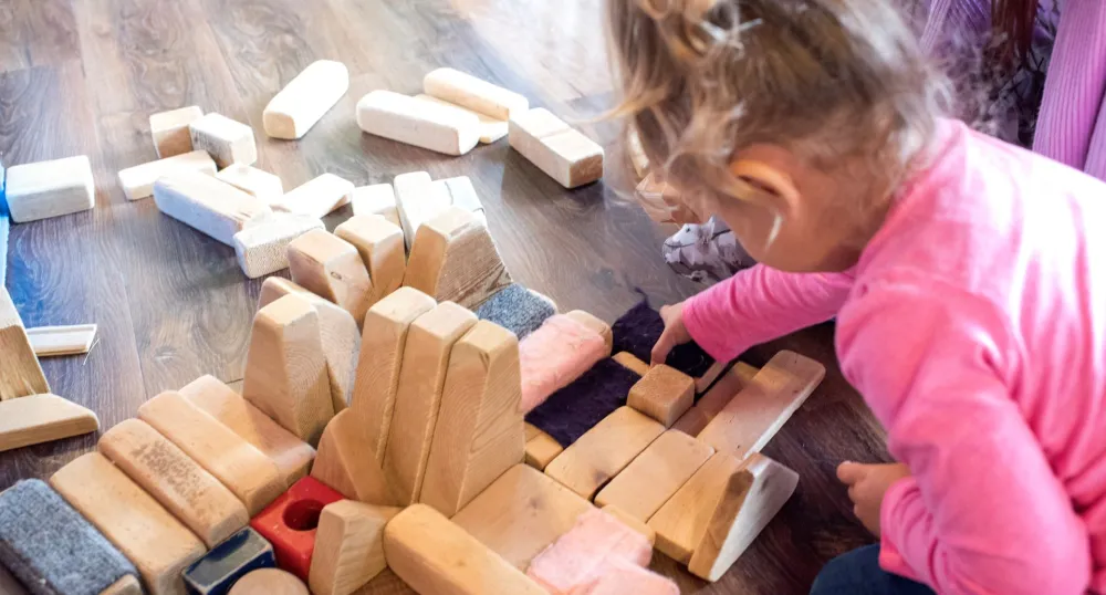 little girl playing with blocks