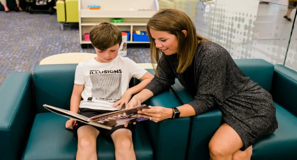 Woman reading book to child
