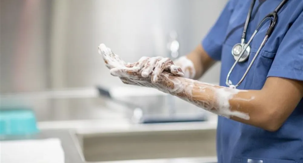 A close up of a doctor washing their hands.