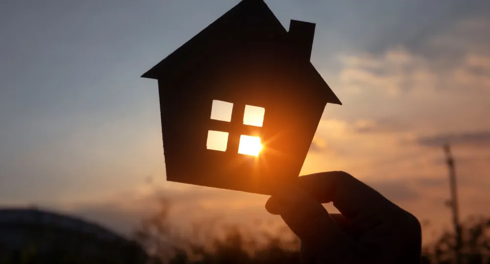 cardboard house cutout with the sun in the background