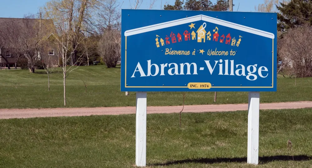 A community sign for Abram-Village.