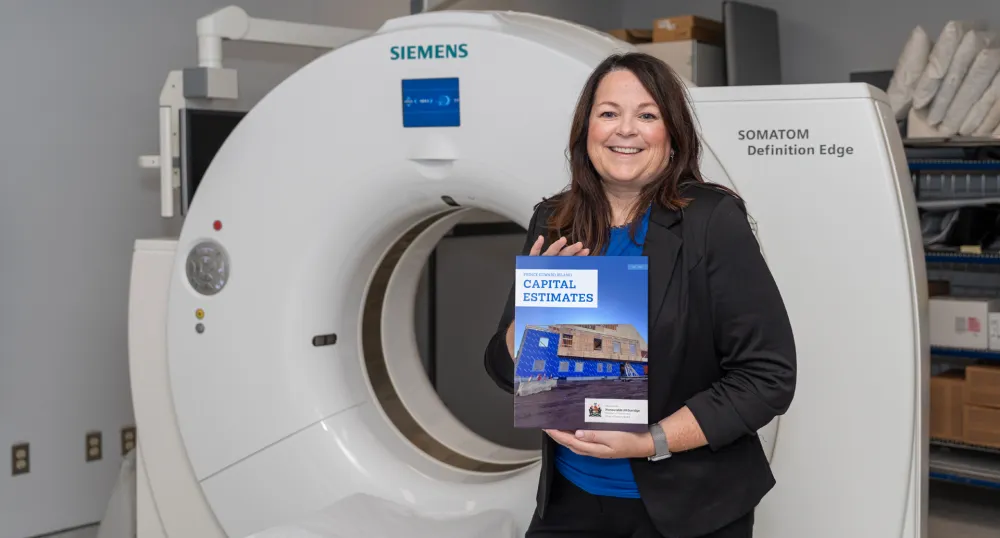 Finance Minister Jill Burridge holding the cover of the 2025 Capital Budget