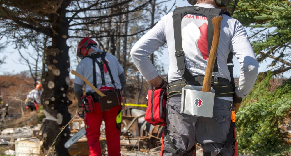 Two members of Team Rubicon Canada wearing their greyshirts.
