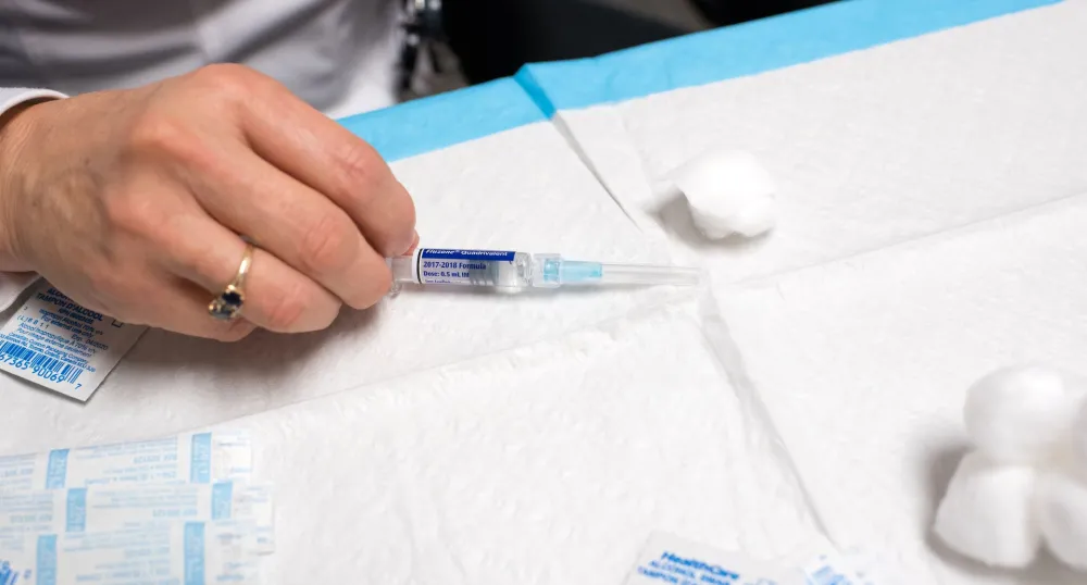 Nurse getting a vaccine ready to administer