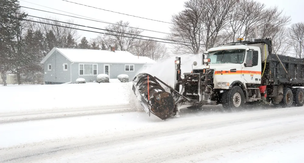 A Department operated snowplow clearing snow off of a roadway.