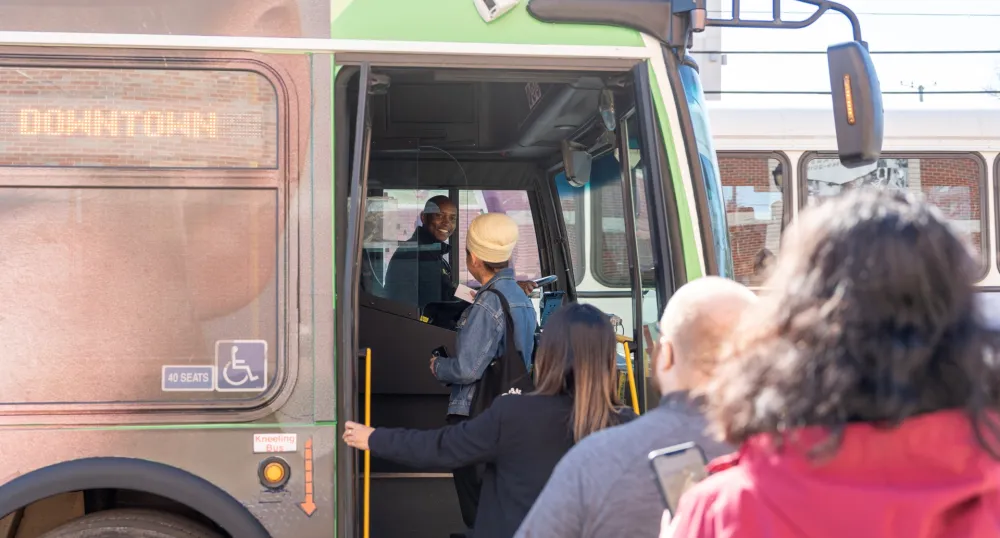 People boarding a public transit bus.
