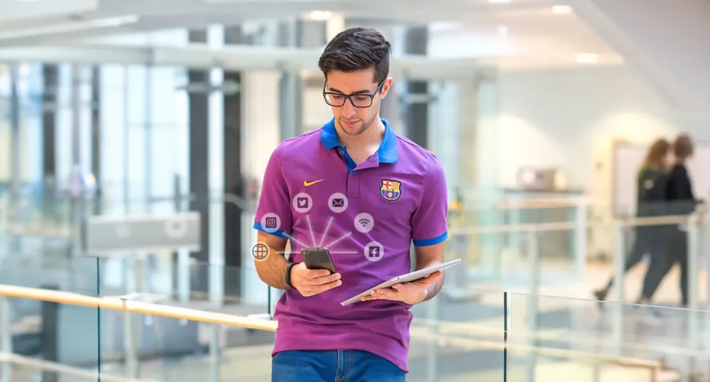 Man holding cell phone with social icons