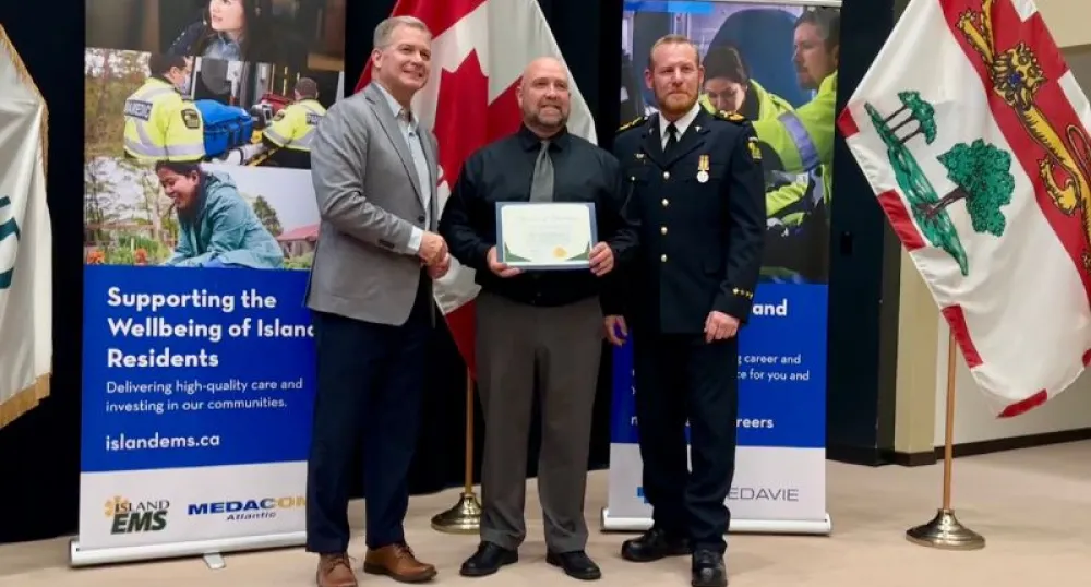 Three white men stand next to each other posing for a photo.