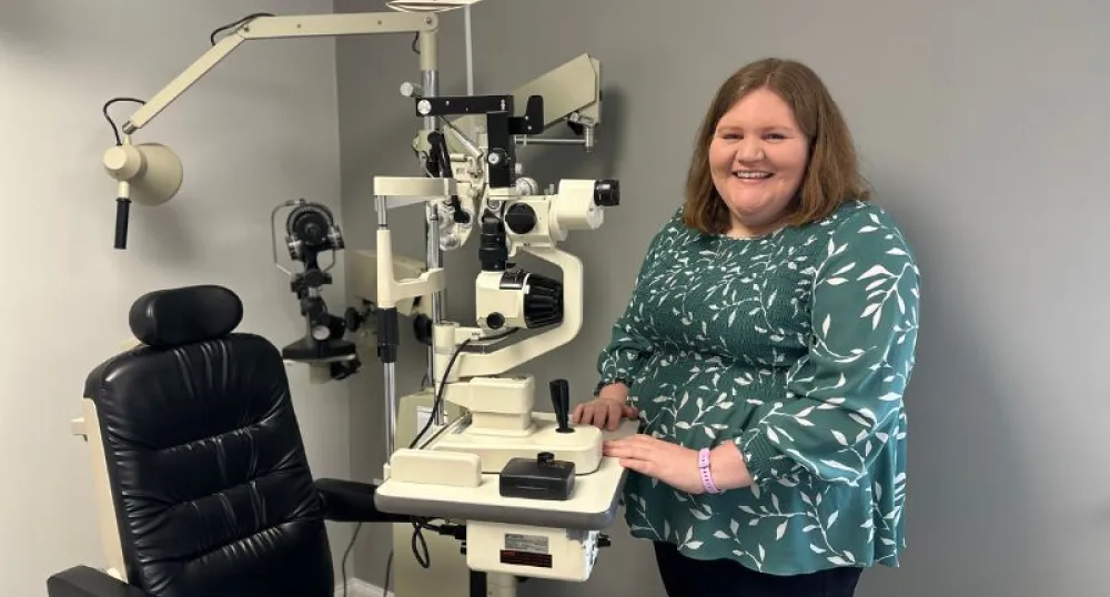 Dr. Wood pictured next to the mobile eye exam