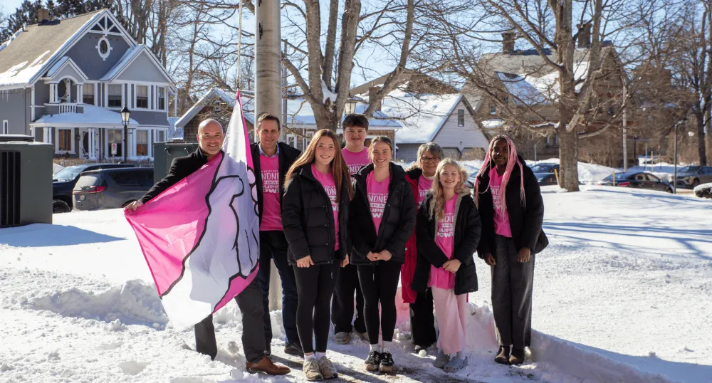 Adults and children wear pink shirts for anti-bullying.