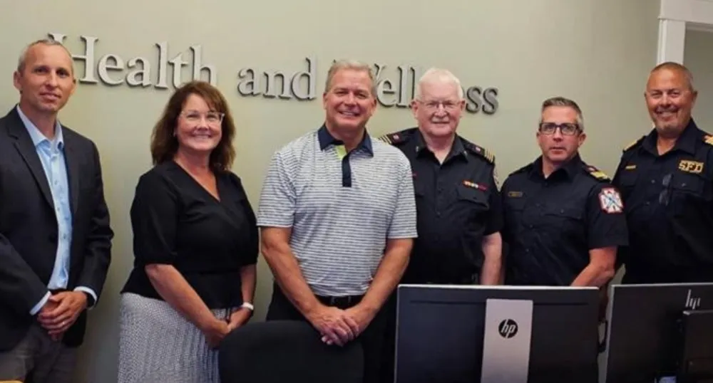 Five men and one woman stand next to each other.
