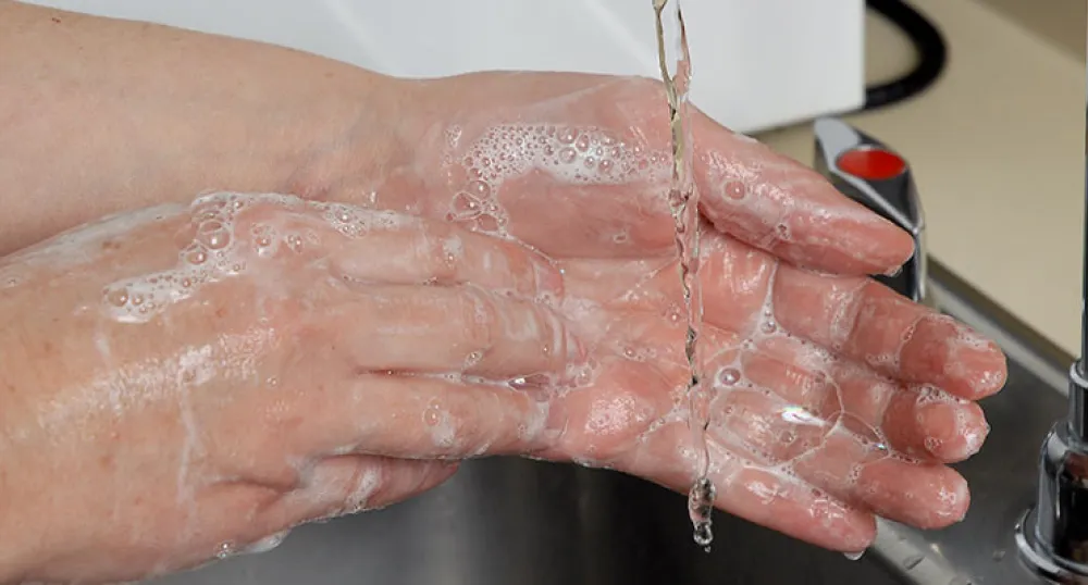 Image of female washing her hands