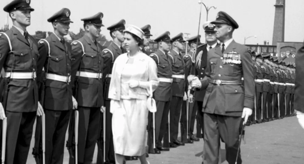 Queen Elizabeth II inspecting a lineup of military personnel at the Charlottetown waterfront during the Royal Visit to Prince Edward Island in 1959.