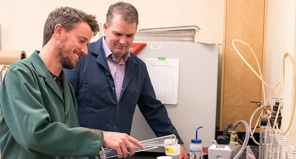 Two people looking at lab equipment