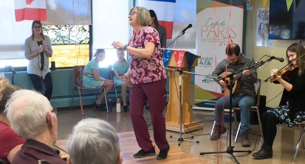 Iain MacInnes and Karine Gallant play while resident care worker Barb Feehan dances for residents of Beach Grove Home.