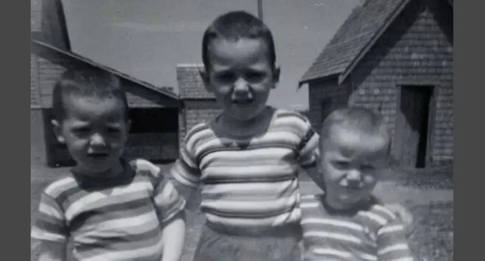 Carter Jeffrey stands in the middle of two of his brothers in a photo taken when they were children.