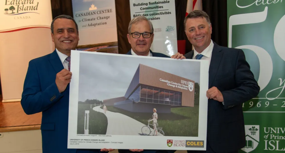 UPEI president Abd-El-Aziz, PEI Premier KIng and MP MacAulay stand holding an artists rendition of the new research centrer