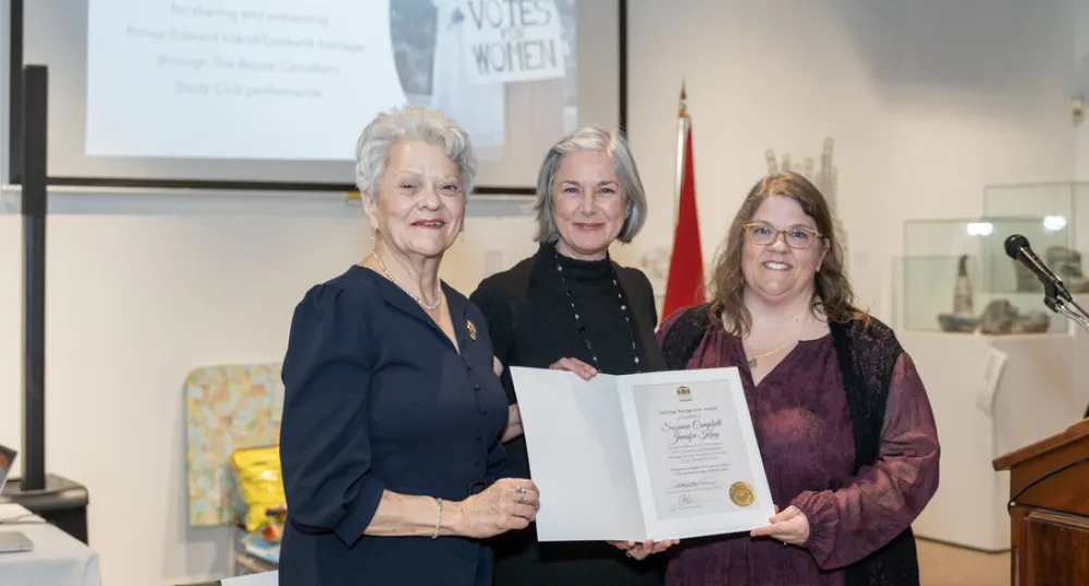 image of three people standing shoulder to shoulder and holding a certificate