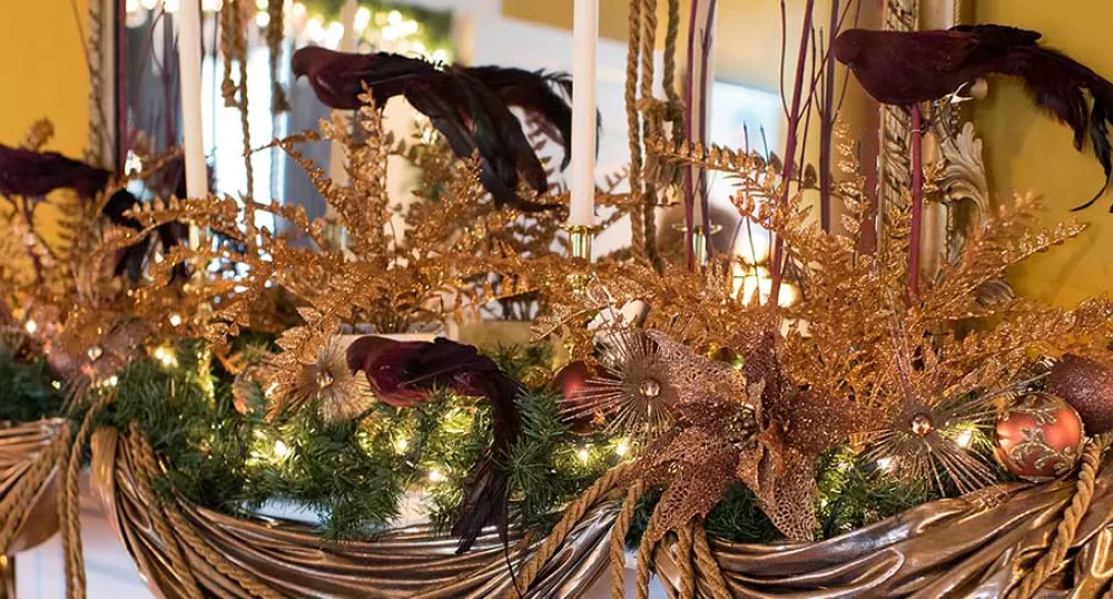 Photo shows Christmas decorations on a mantle at Government House