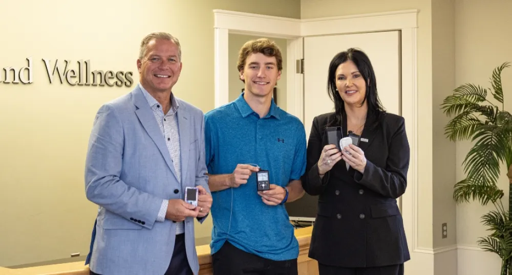 Image of 3 pople holding insulin pump