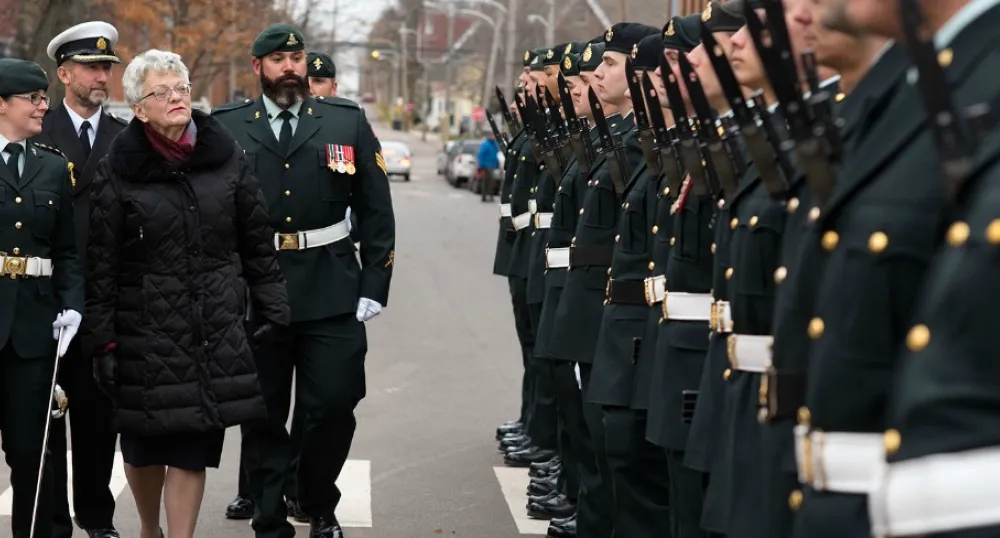 Photo shows lieutenant governor reviewing honor guard