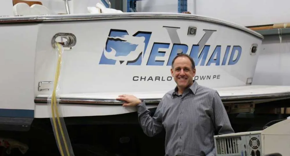 General Manager Ron Savidant stands in front of fishing vessel inside their Charlottetown Industrial Park site