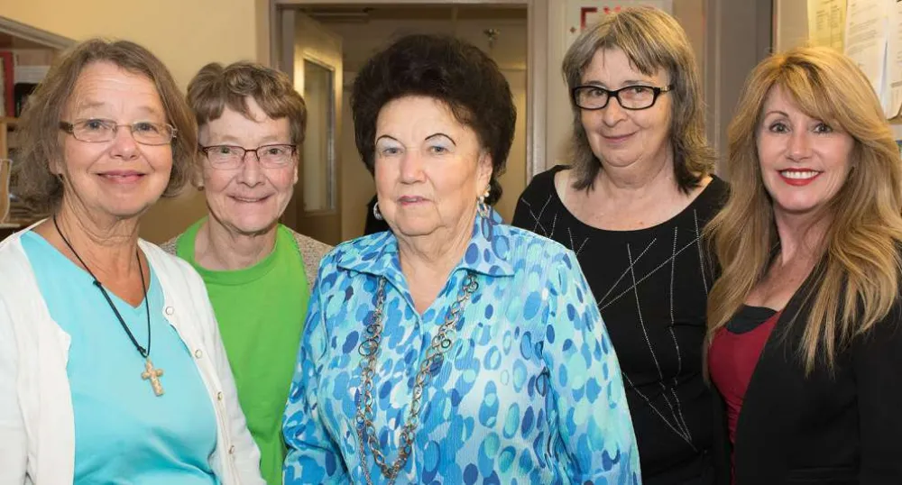 Four senior women standing beside Minister Mundy.