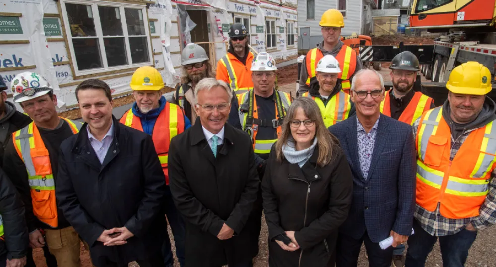 image of people standing shoulder to shoulder at a construction worksite