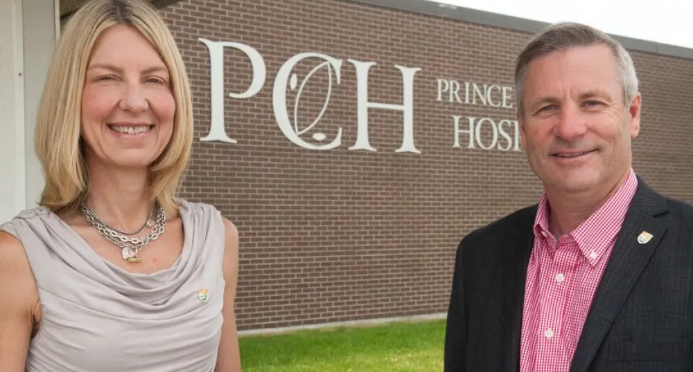 Minister Robert Henderson and Dr. Michele Barton outside Prince County Hospital