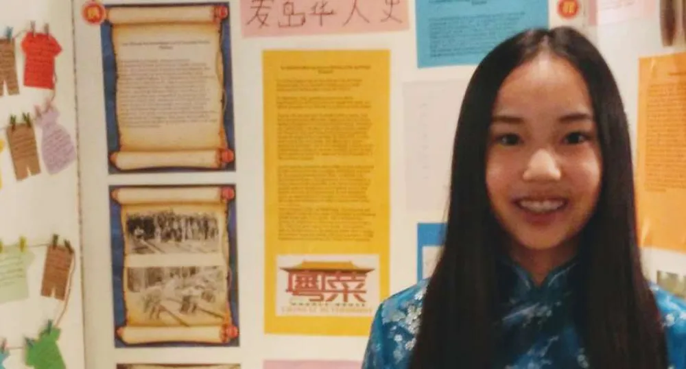 Olivia Lewis stands in front of her heritage display on 'L’immigration Chinoise au Canada' at the PEI Heritage Fair
