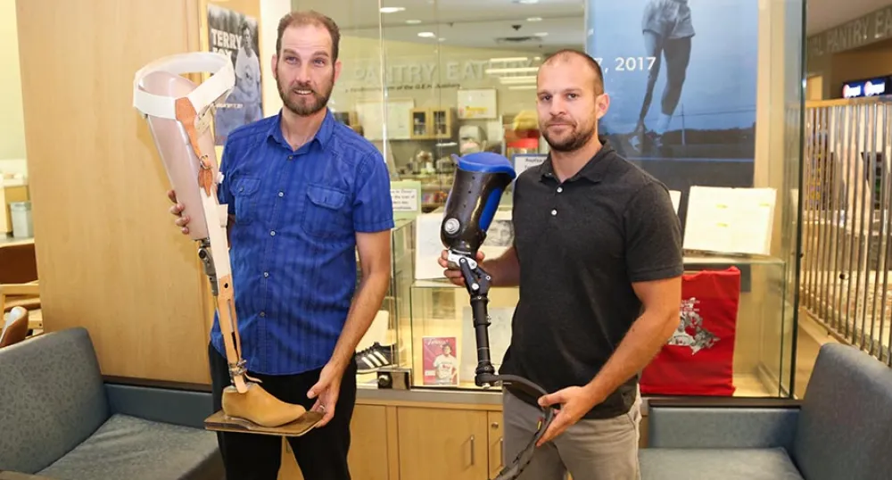 QEH prosthetic technicians Paul Hoar and Gabe Arsenault display prosthetic legs
