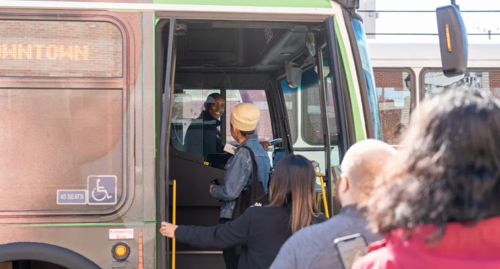 image of people getting onto a transit bus