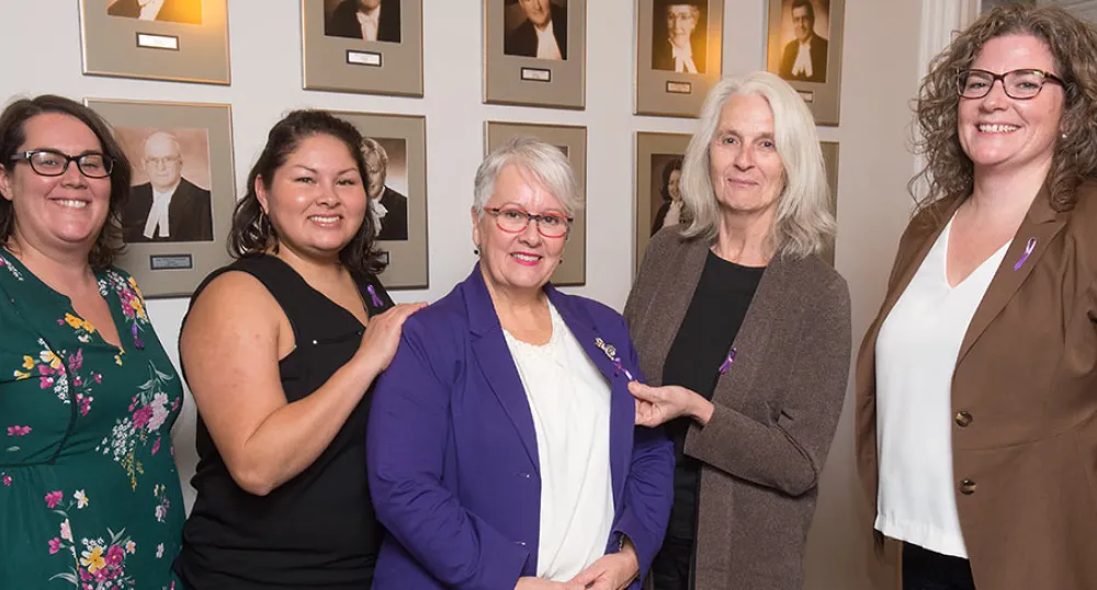 Representatives from four community organizations that will receive funding to help Island women feel safe from the threat of violence stand with Minister Paula Biggar