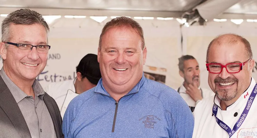 Minister MacDonald and two others stand in the PEI Shellfish event tent