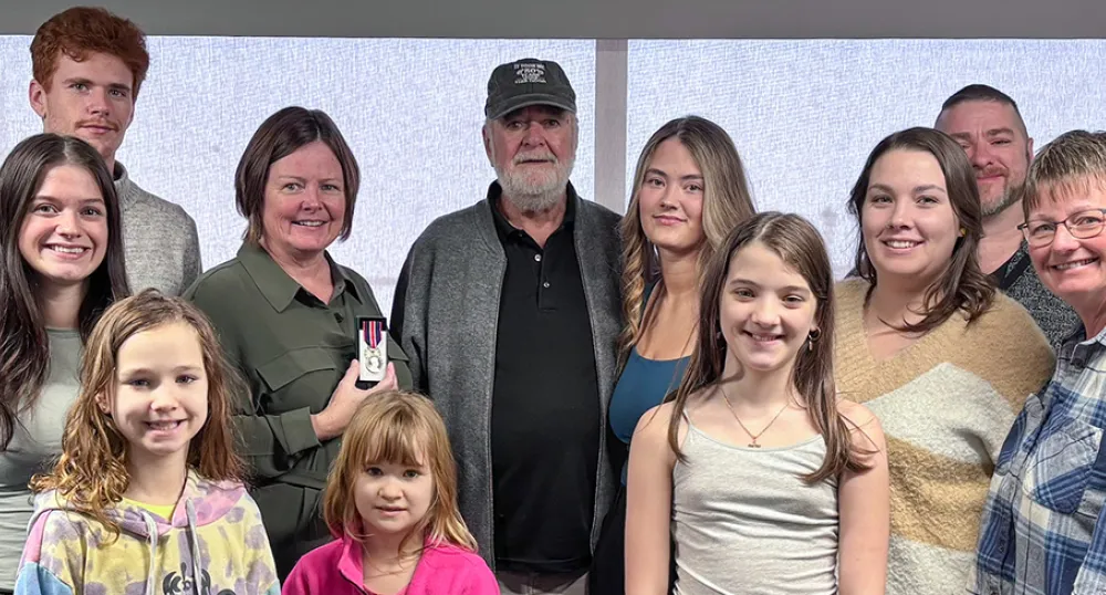 Surrounded by her family, Sue Doucette, provincial palliative home care clinical development coordinator and recipient of the King Charles III medal.