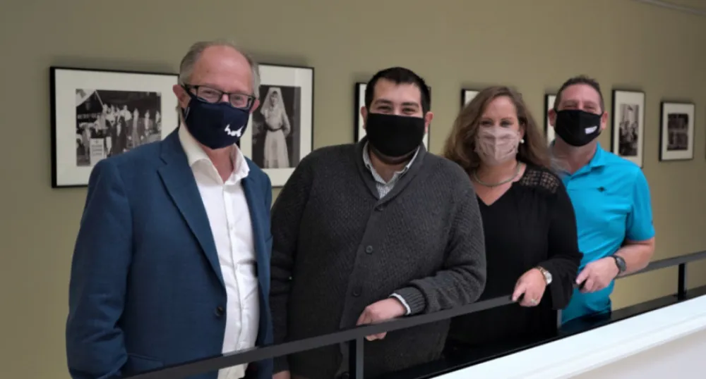 Standing against a railing: Health and Wellness Minister Ernie Hudson. Minister, Hunter Guindon, Sherri Carmichael, Ray Carmichael