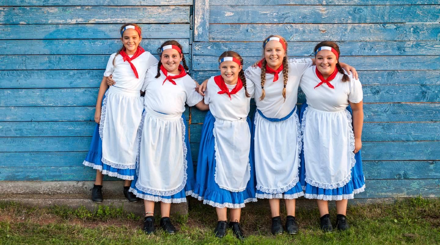 people dressed in Acadian colours