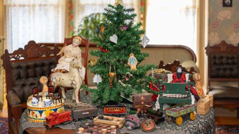 Antique Christmas decorations laid out on a table.