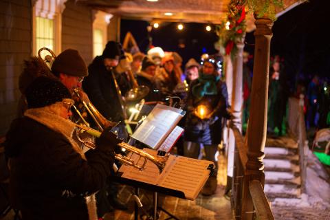 Musicians perform on a porch as part of the River Clyde Solstice Walk. 