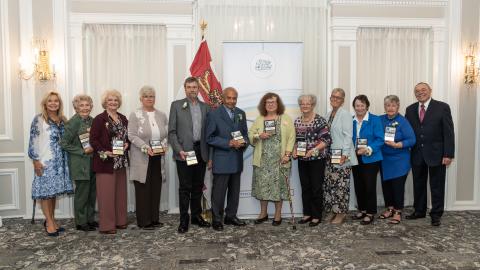 Ten seniors stand next to each other with their awards.