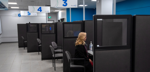 AccessPEI service center with numbered cubicles and a person seated at one desk