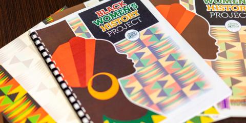 image of a booklet lying flat on a table with other booklets