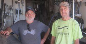 Brothers Johnny and Gary Gallant stand in milking parlour of their dairy farm