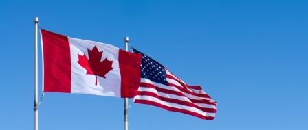 iStock-169969337 iStock image of Canada and USA flags outdoors