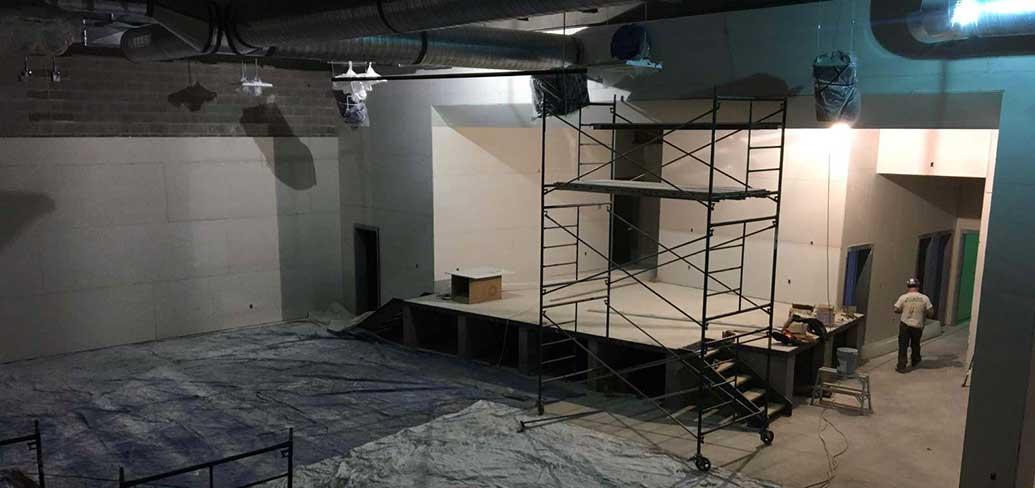 Photo shows interior construction of a large space at the new French school.